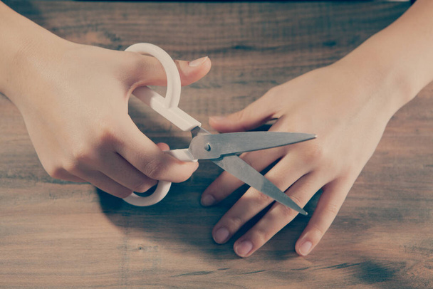 young woman holding large scissors - Foto, Bild