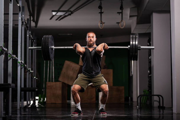 Muscular athlete lifting very heavy barbell.  - Fotó, kép