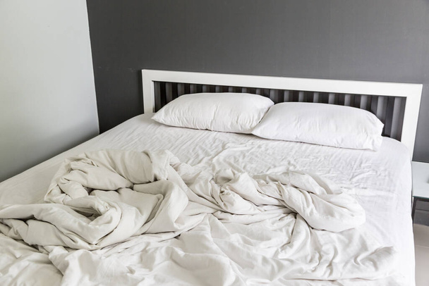 Dva bílé polštáře na posteli a přikrývka s vrásčitým nepořádkem v ložnici - Fotografie, Obrázek