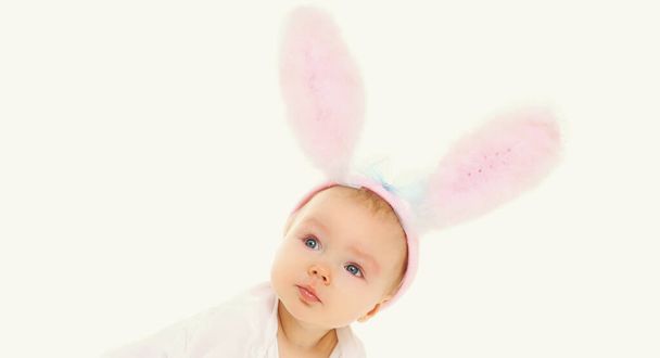 Portrait of sweet baby with pink rabbit ears over a white background - Foto, imagen