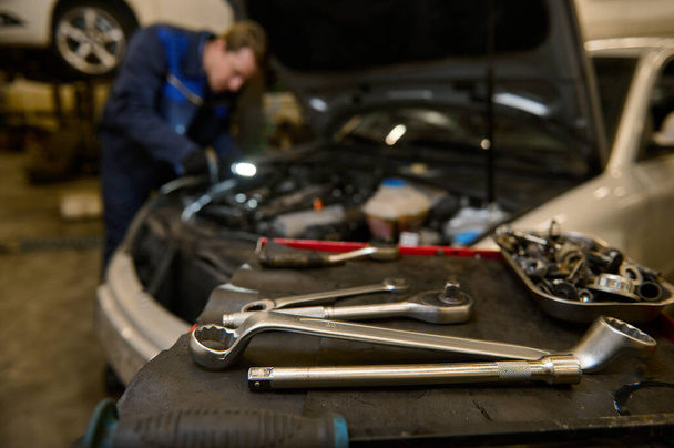 Focus on wrench and professional tools for repairing and inspecting automobiles lying - Foto, Imagem