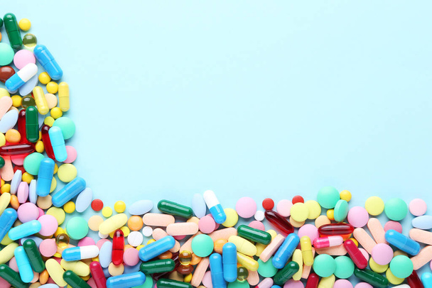 Colorful pills on blue background - Foto, imagen