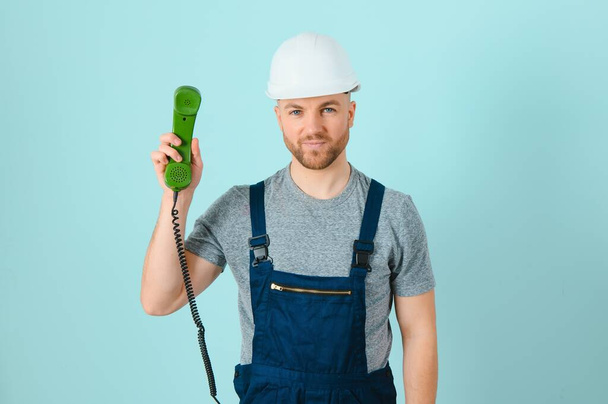 Please call this number, I will assist you. Craftsmen Craftsmen or electrician man with phone isolated background - Valokuva, kuva