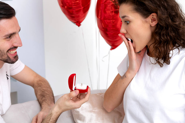 Man makes a proposal with the engagement ring at the Valentines day celebration - 写真・画像