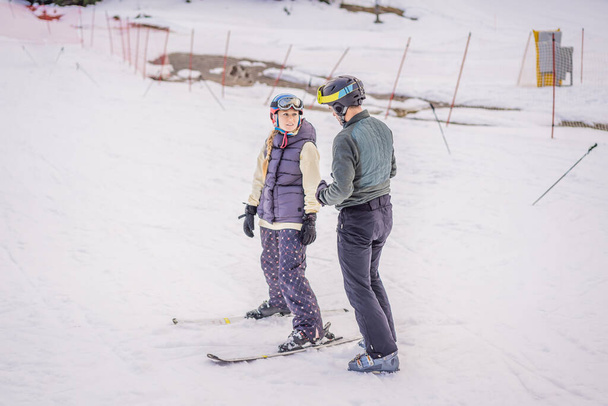 Woman learning to ski with instructor. Winter sport. Ski lesson in alpine school - Zdjęcie, obraz