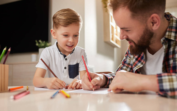 Happy father and son drawing together - 写真・画像