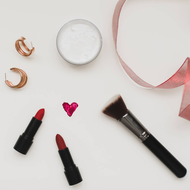  Concept Womens Day, Valentines Day, March 8. Lipsticks, cosmetic makeup products and accessories flatlay top view.  - Fotografie, Obrázek