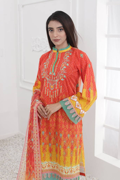 A Pakistani shalwar kameez suit with dupatta. Pakistani model is shown her dress with style. - Photo, Image