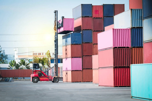 container forklift with a pile of containers beautiful evening background - Photo, Image