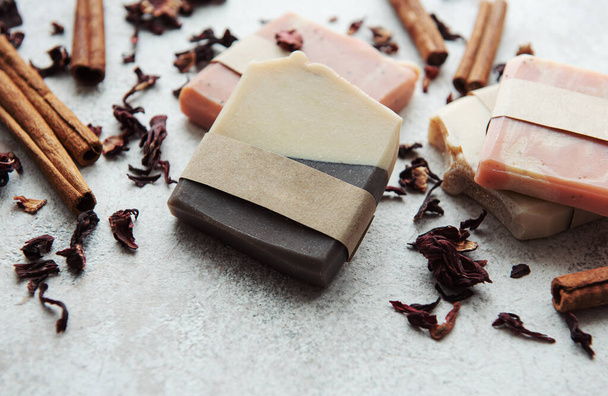 Spa setting witn natural handmade soap with cinnamon and flower petals  - Fotó, kép