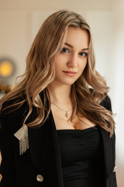 Portrait of elegant beautiful young girl in black luxury suit with blazer at celebration evening party - Φωτογραφία, εικόνα
