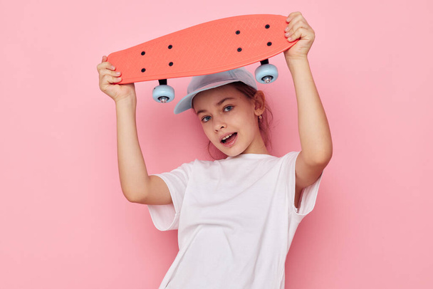 little girl with a skateboard in hand isolated background - Foto, Imagem