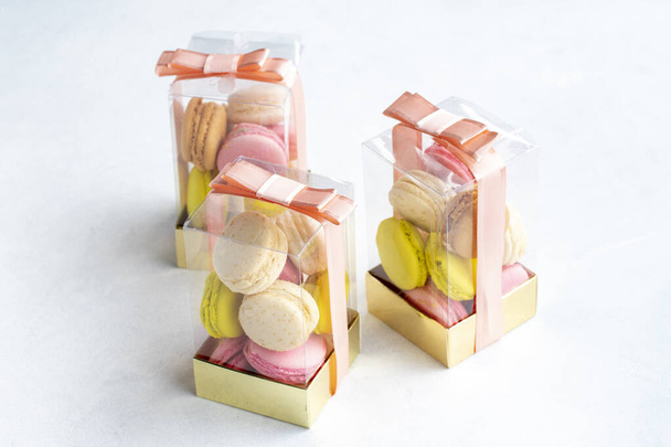 Packed macarons on a white background. Packaged macarons for gifting - Photo, Image