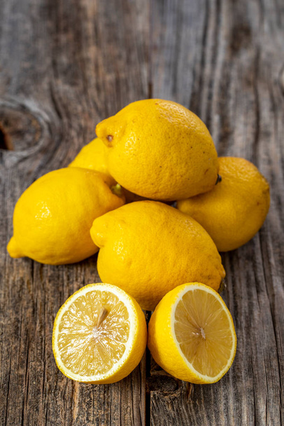 fresh ripe lemons on wood background. Close up - Fotó, kép