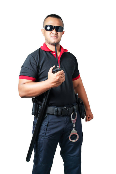 Security guards wear dark glasses. stand holding a radio There are rubber batons and handcuffs on the tactical belt. on isolated white background cut out security concept - Photo, Image