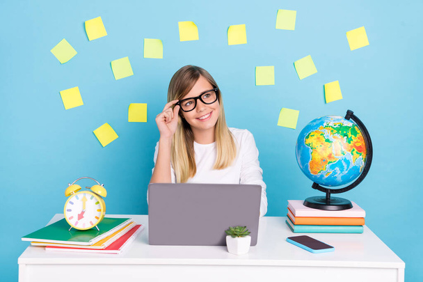 Portrait of attractive trendy minded cheery girl using laptop brainstorming creating idea isolated over bright blue color background - Фото, изображение