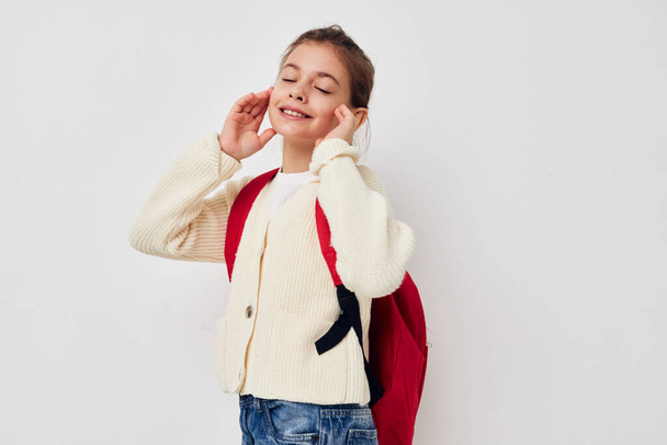 little schoolgirl with red backpack posing Lifestyle unaltered - 写真・画像