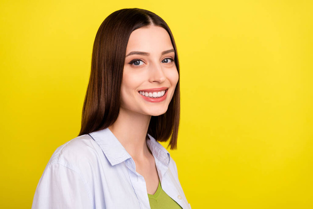 Profile photo of cute brunette millennial lady wear blue shirt isolated on yellow color background - Fotó, kép