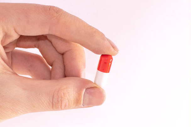 tablet capsule is held in the hand with your fingers - Photo, Image