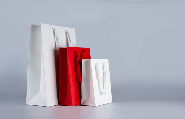 Various sizes of holiday shopping gift bags on white background.  - Zdjęcie, obraz