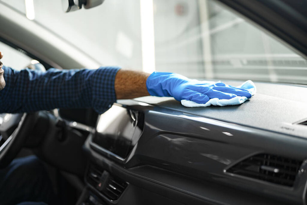 A man cleaning car interior, car detailing in Carwash service - Zdjęcie, obraz