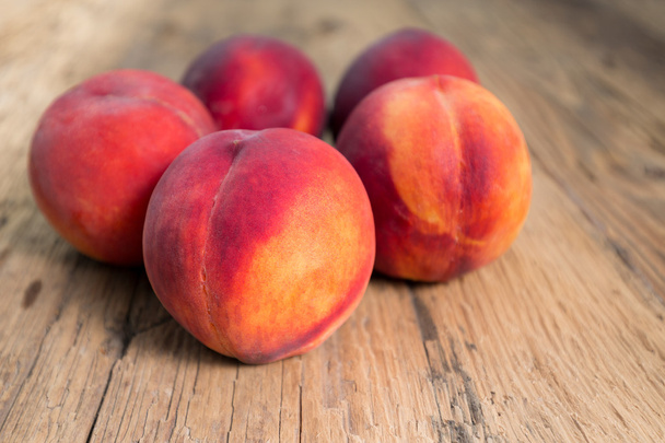 Peaches on a wooden table - Фото, зображення