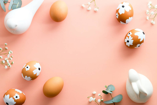 Elegant Easter flat lay composition. Painted Easter eggs, gypsophila, bunny, bird on pastel pink background. Top view with copy space. Happy Easter concept. Minimal style. - Фото, зображення