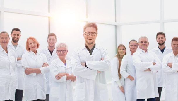 confident scientific leader standing in front of a team of young scientists. - 写真・画像