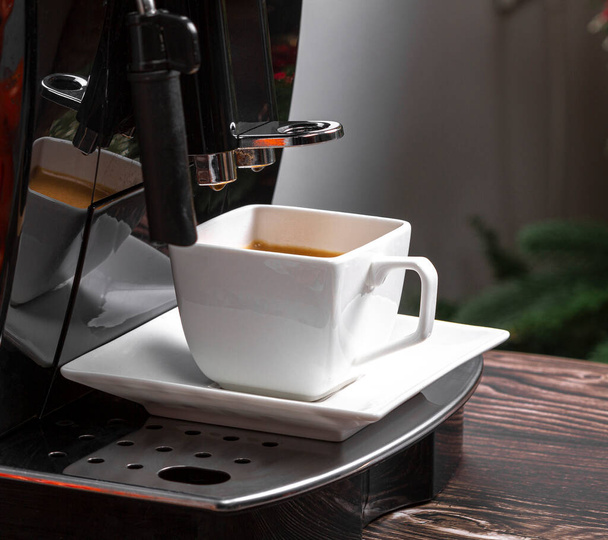 Moderne espressomachine met een kopje koffie close-up. Espresso koffie. - Foto, afbeelding
