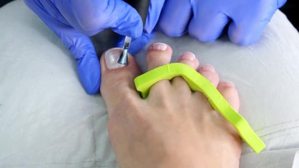 Pedicure beauty salon. Nail polishing with nail polish. French. close up. - Footage, Video