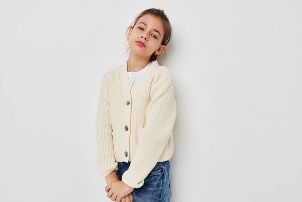 little girl posing in a white sweater childhood unaltered - 写真・画像