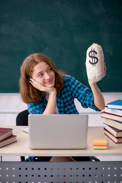 Young female student in expensive education concept - Photo, Image