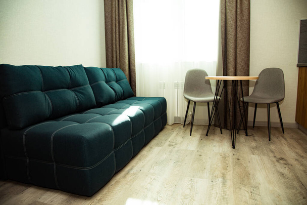 blue,soft,cozy sofa in the stylish interior of the hotel room - Φωτογραφία, εικόνα