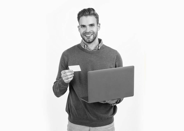 happy man businessman hold debit card and computer for paying online, buying online - Photo, Image