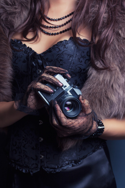 Woman holding vintage camera - Fotó, kép