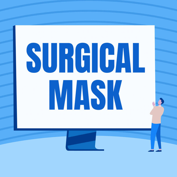 Handwriting text Surgical Mask. Concept meaning worn by health professionals during surgery and during nursing Man Standing Drawing Looking At Large Monitor Display Showing News. - Photo, Image