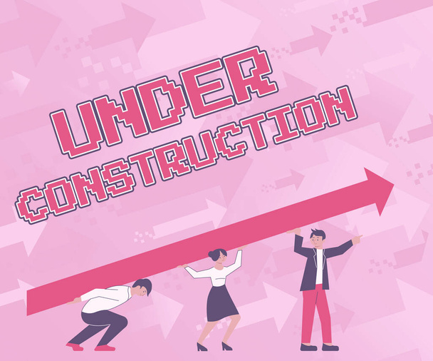 Text sign showing Under Construction. Concept meaning building that is unfinished but actively being worked on Four Colleagues Drawing Standing Holding Large Arrow For Success. - Photo, Image