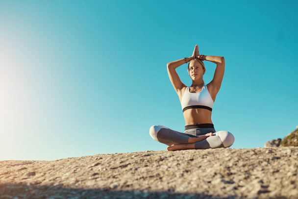 I do yoga, do you. Shot of a young woman doing yoga at the beach. - Zdjęcie, obraz