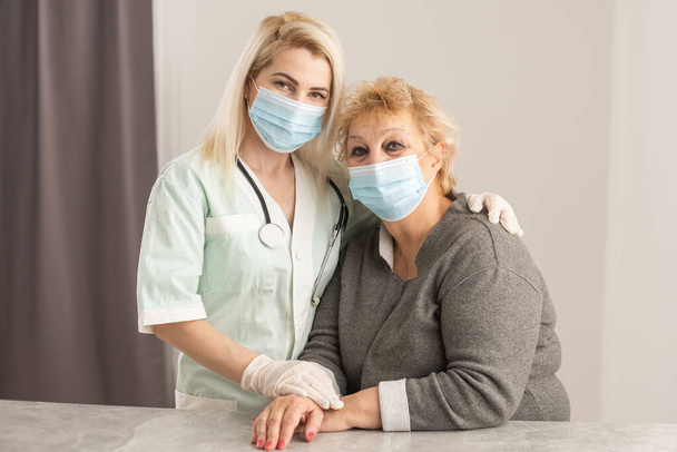Senior woman with her caregiver at home - Photo, Image