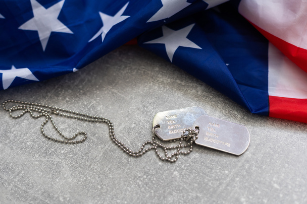 Authentic military dog tag on an american flag - Fotó, kép