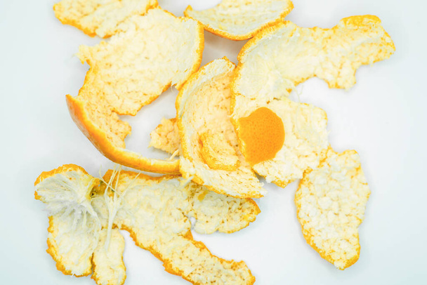Orange peel on a white background, close-up. - Photo, Image