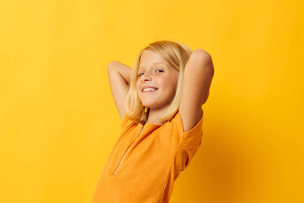 kid girl smile hand gestures posing casual wear fun color background unaltered - Fotó, kép