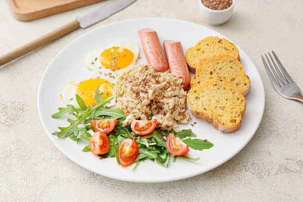 Plate with tasty breakfast on grunge background - Photo, Image