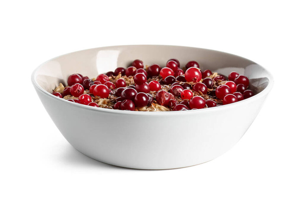 Bowl with tasty oatmeal, flax seeds and cranberries on white background - Valokuva, kuva