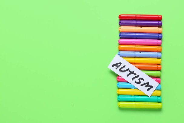 Colorful markers with word AUTISM on color background - Photo, Image