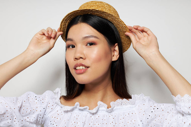 woman with Asian appearance stylish clothes hat fashion isolated background unaltered - Valokuva, kuva