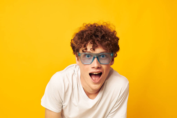 guy with red curly hair in blue glasses white t-shirt fashion modern style isolated background unaltered - Φωτογραφία, εικόνα