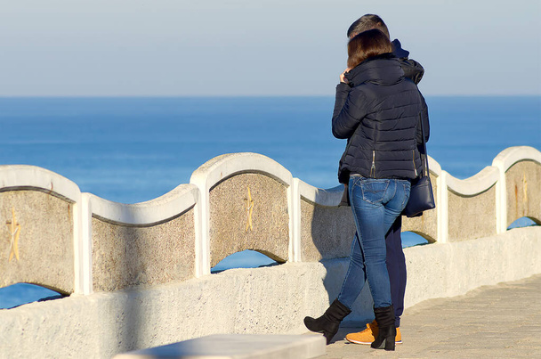 Ένα ζευγάρι εραστών μπροστά στη θάλασσα με θέα στη θάλασσα - Φωτογραφία, εικόνα