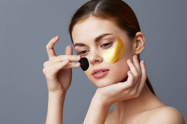 pretty woman skin care face patches bare shoulders wrinkle smoothing close-up Lifestyle - Foto, Imagen