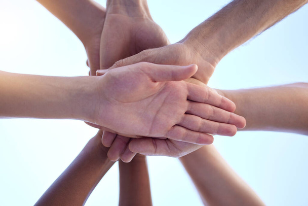 Motivating and building each other up. Shot of a group of people with their hands stacked together. - Фото, зображення